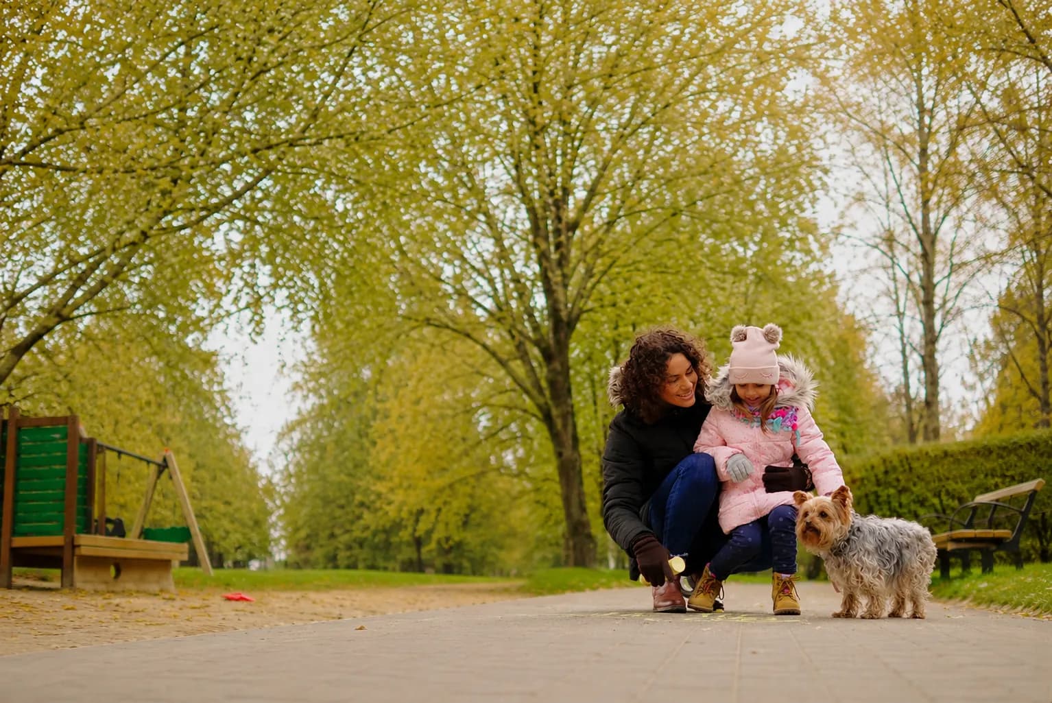 Mother and daughter spending time with their dog in a Surrey park